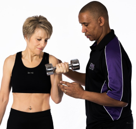 Picture of older woman lifting a weight being guided and coached by a man